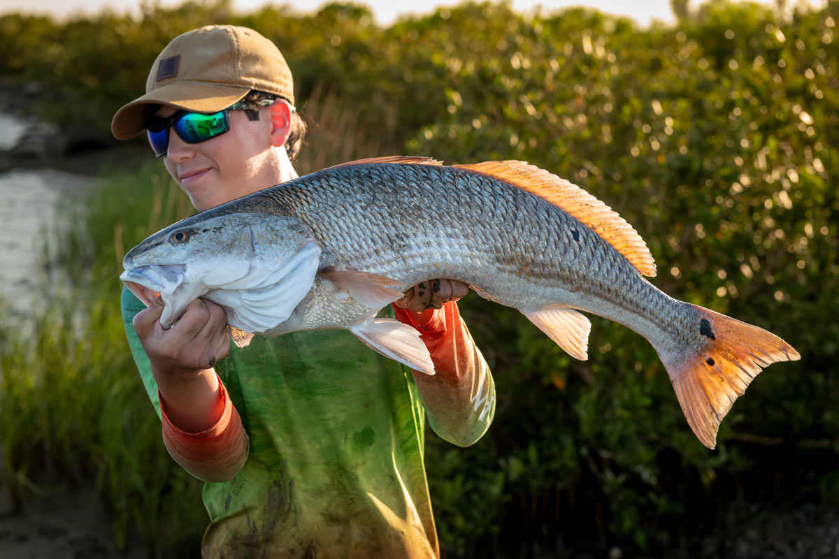 young man with big fish